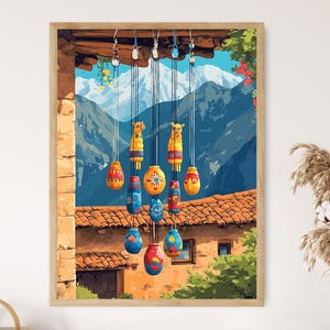 May include: A framed print of colorful hanging ornaments against a backdrop of mountains and a terracotta-tiled roof. The ornaments are in various shapes and colors, including yellow, blue, and red. The artwork evokes a sense of cultural heritage and craftsmanship.