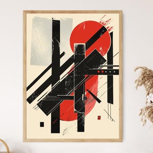 May include: Abstract art print with geometric shapes in black, red, and grey on a cream background. The artwork includes a large red circle, black lines, and rectangular shapes, framed in a light wood frame.
