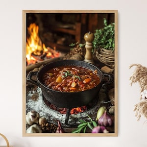 May include: A framed image of a cast iron pot filled with a hearty stew, simmering over a small fire. The stew contains vegetables and herbs. The background features a fireplace with a burning fire and a wooden table.