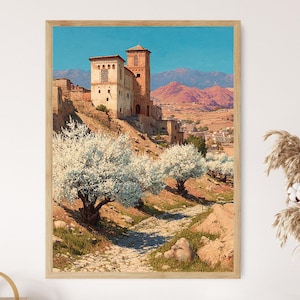 May include: A framed landscape print depicts a sunlit scene of a stone castle on a hillside, with white flowering trees in the foreground. The sky is a clear blue, and distant mountains are visible.