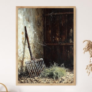May include: A framed print of a rustic scene featuring a weathered pitchfork leaning against a textured wall. The artwork has a muted color palette with brown, beige, and green tones, evoking a sense of age and rural life. A small pile of green foliage rests at the base.