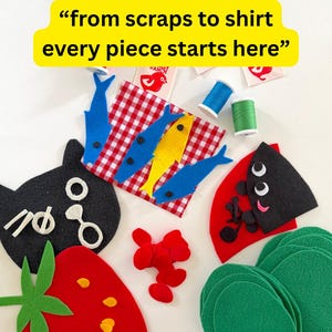 May include: A collection of felt craft pieces including a red strawberry, a black cat face, blue and yellow fish on a red gingham square, green circles, and red shapes. Includes spools of blue and green thread, scissors, and labels with text.