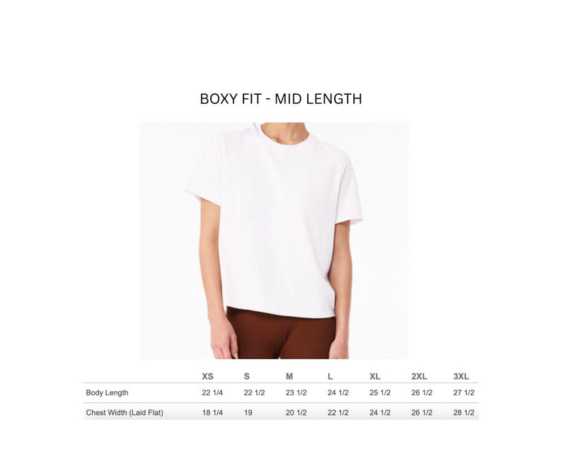 May include: A white, boxy fit, mid-length t-shirt. The image includes a size chart with body length and chest width measurements in inches for sizes XS to 3XL. The shirt is shown on a person wearing brown pants.