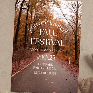 May include: An invitation card with a scenic autumn forest background. The text "You are invited FALL FESTIVAL" is displayed in white, along with event details: Food, Games, Music, date 9.10.25, location, and time.