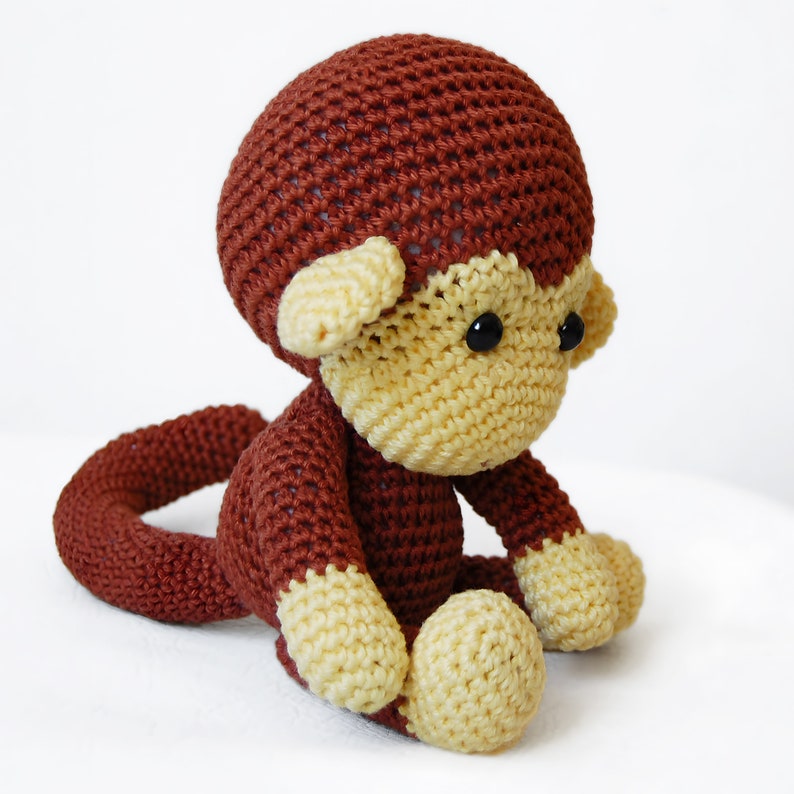 Amigurumi monkey, sitting on the table.