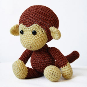 Amigurumi monkey, sitting on the table.