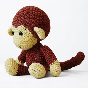 Amigurumi monkey, sitting on the table.