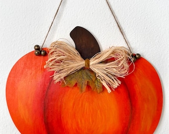 Hand-painted Halloween pumpkin as a door hanger or home decoration. Autumn/door decoration. Hand-painted wooden slice. Pumpkin decoration. Halloween.