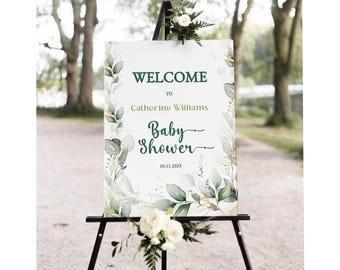 May include: Welcome to Catherine Williams' Baby Shower sign with a green and gold leafy design. The date is 10.11.2023.