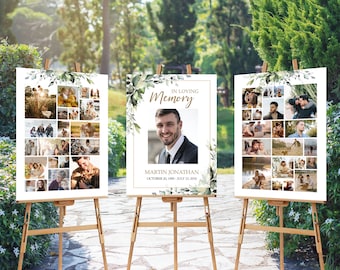 May include: Three white signs with a green leafy border and gold accents. The center sign reads "In Loving Memory" with a photo of a man and the text "Martin Jonathan October 20, 1985 - July 13, 2019". The signs are on wooden easels.
