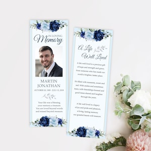 May include: A blue and white floral bookmark with a photo of a man and the text "In Loving Memory, Martin Jonathan, October 20, 1985 - July 13, 2018". The bookmark also includes the text "A Life Well Lived" and a poem about the meaning of a life well lived.