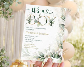 Puede incluir: Una invitación a una baby shower de 'Es un niño' con un diseño de hojas doradas y verdes. La invitación incluye la fecha, la hora y la ubicación de la ducha. También incluye los nombres Catherine & Jonathan.