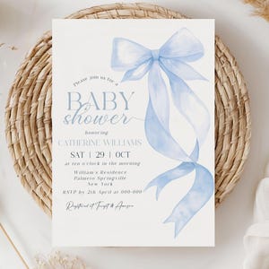 May include: A baby shower invitation with a light blue watercolor bow and ribbons. The invitation includes the text "BABY shower" and details for Catherine Williams' shower on October 29th. The invitation is on a white background.