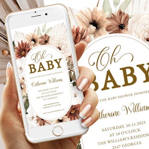 May include: A baby shower invitation displayed on a smartphone screen. The design features the words "Oh Baby" in elegant script, surrounded by floral elements in shades of brown, cream, and green. The invitation includes event details.