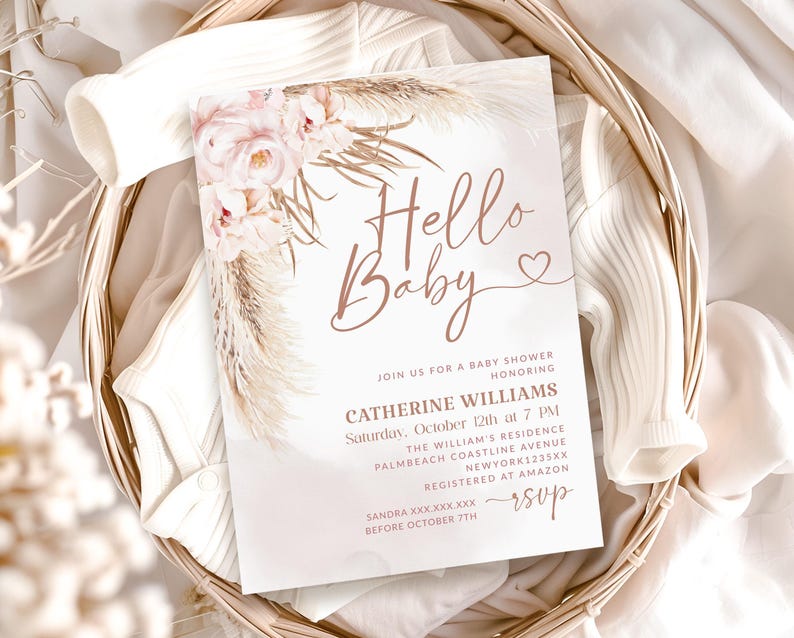 May include: A baby shower invitation with the words "Hello Baby" in a delicate script, adorned with floral and pampas grass accents. The invitation includes details for Catherine Williams' baby shower, set against a soft, neutral background.