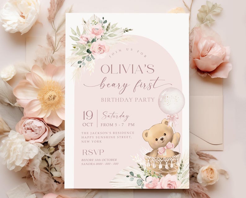 Pink floral first birthday invitation featuring a teddy bear in a basket, pastel flowers, and a balloon for a baby girl's Beary First birthday party