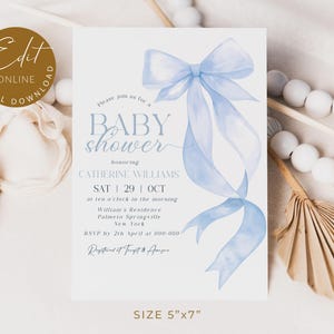 May include: A baby shower invitation with a light blue watercolor bow and ribbons. The invitation includes the text "Baby Shower" and event details. The card measures 5" x 7".