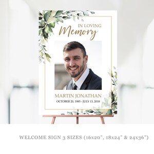 May include: A white welcome sign with a gold frame and green floral accents. The sign reads "In Loving Memory" with a photo of a man and the text "Martin Jonathan October 20, 1985 - July 13, 2018". The sign is available in three sizes: 16x20 inches, 18x24 inches, and 24x36 inches.