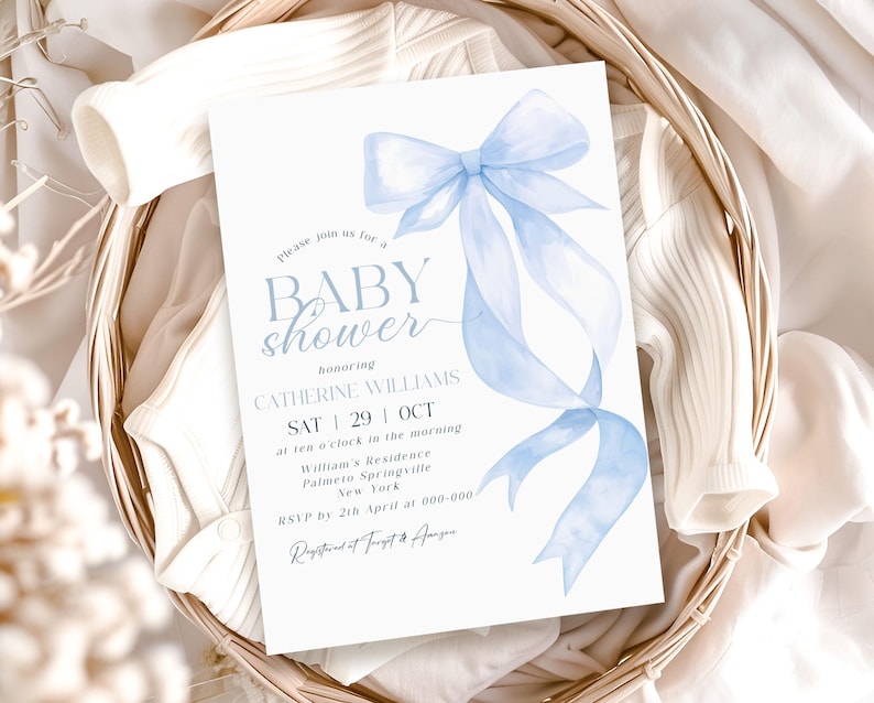 May include: A baby shower invitation with a light blue watercolor bow and ribbon design. The invitation includes the text "BABY shower" and details for Catherine Williams' shower, including the date, time, and location in New York.