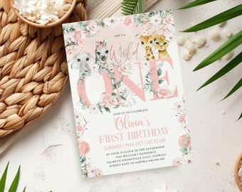 May include: A pink and white invitation for a first birthday party. The invitation features the text "She's a Wild One" and "Olivia's First Birthday". The design includes floral elements and illustrations of safari animals.