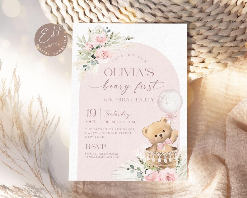 Pink floral first birthday invitation featuring a teddy bear in a basket, pastel flowers, and a balloon for a baby girl's Beary First birthday party