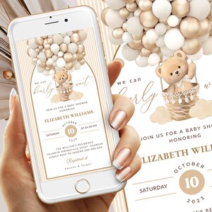 May include: A digital invitation for a baby shower featuring a teddy bear in a hot air balloon made of gold and white balloons. The text reads "We can barely wait" and "Join us for a baby shower honouring Elizabeth Williams, Saturday 10th October 2023, at 4:00 PM. The William's Residence, Palmetto Springville 62567, Georgia. Kindly RSVP to Sandra on 800-000-000. Registered at Amazon & Target."
