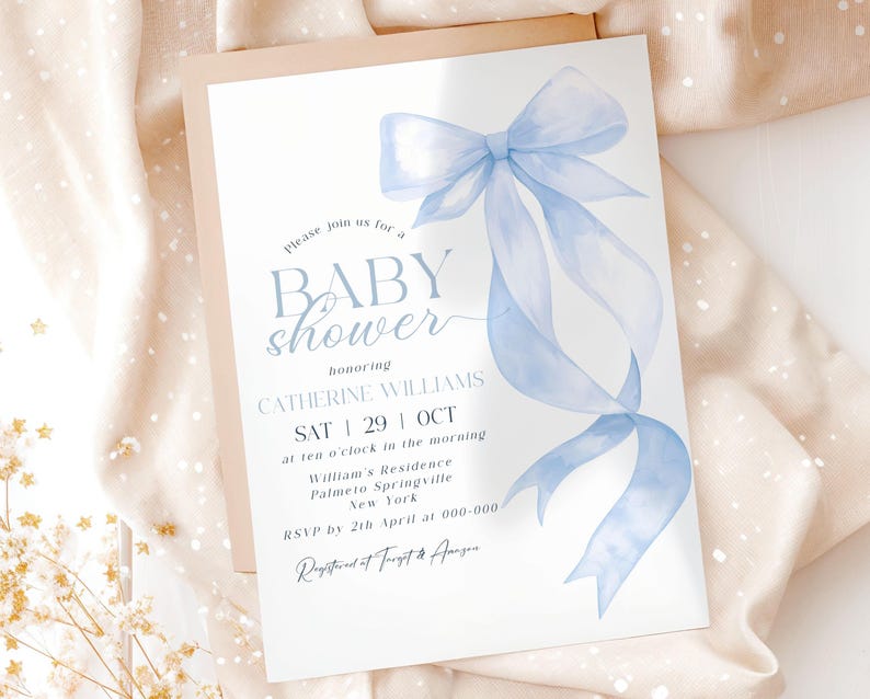 May include: A baby shower invitation featuring a light blue watercolor bow and ribbon design. The invitation includes the text "BABY shower" and details for Catherine Williams' baby shower, including the date, time, and location.