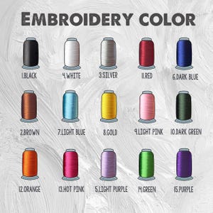 May include: Image showing a color chart for embroidery thread. The chart displays 15 different thread colors, including black, white, silver, red, dark blue, brown, light blue, gold, light pink, dark green, orange, hot pink, light purple, green, and purple.