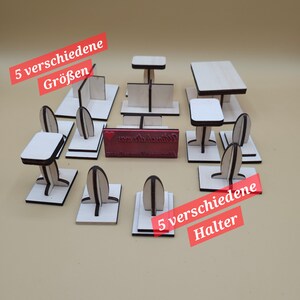 May include: Five different sizes of wooden table and chair sets, with five different sizes of wooden holders. The sets are made of unfinished wood and are ready to be painted or stained. The holders are designed to hold the table and chair sets in place.