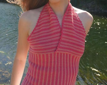 May include: A pink and light pink striped halter top. The top is knit with a vertical and horizontal striped pattern. The halter top has a v-neck and is sleeveless. The top is made of a soft, comfortable material.