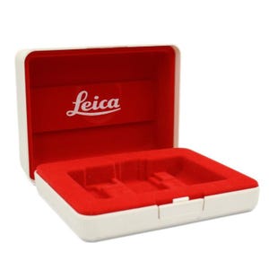 May include: White storage box with a red velvet interior. The box has the word "Leica" printed on the lid.