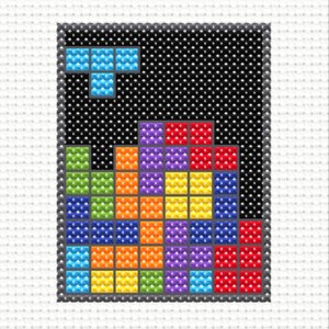 Image of a close up of a mini cross stitch of an 80s puzzle video game.