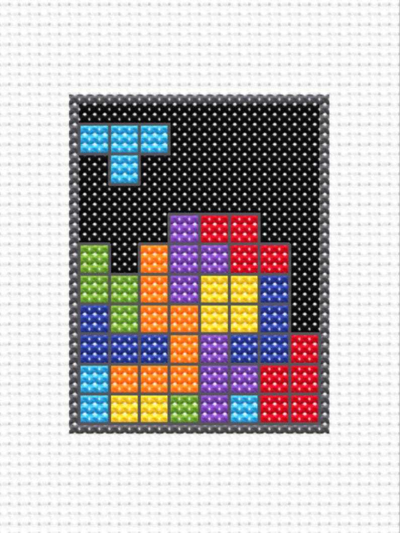 Image of a close up of a mini cross stitch of an 80s puzzle video game.