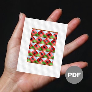 May include: A digital cross stitch pattern featuring a repeating pattern of red, green, white, and black flowers. The pattern is available as a PDF download.