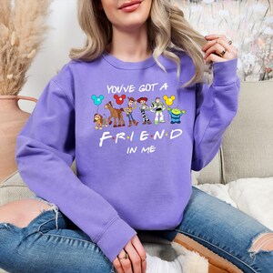 May include: Purple sweatshirt with a graphic of Disney characters holding balloons that says "You've got a friend in me".