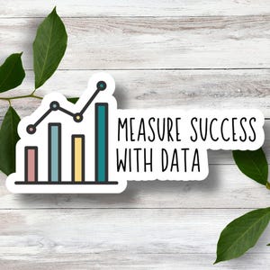 May include: A white sticker with a line graph and the text "MEASURE SUCCESS WITH DATA". The graph is a line graph with five bars, each a different color: pink, blue, green, yellow, and teal. The line graph is going up.