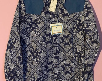 May include: A blue long-sleeved shirt with a white paisley pattern. The shirt has a blue yoke and a tag that says "sportswear".