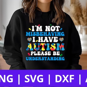 May include: Black sweatshirt with a white graphic design that reads "I'm not misbehaving I have autism please be understanding". The graphic design includes a puzzle piece design in blue, red, yellow, and green.