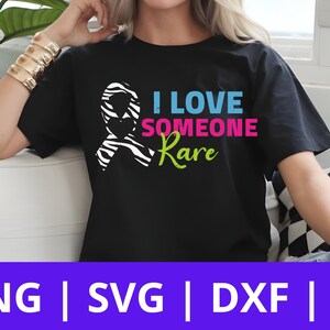 May include: Black t-shirt with a zebra print ribbon and the text "I Love Someone Rare" in pink, blue, and green.