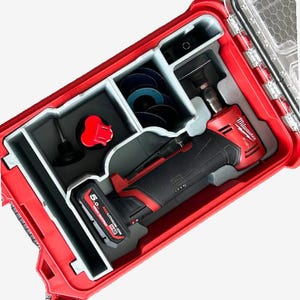 May include: A red and black Milwaukee power tool with a battery and a variety of attachments in a red hard case.