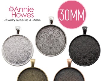 May include: Five 30mm round pendant trays in different metal finishes: silver, black, antique brass, and antique copper. Each tray has a textured surface and a loop for hanging.