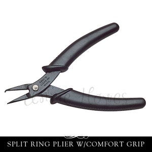 May include: Black split ring pliers with a comfort grip handle. The pliers are made of metal and have a black finish. The handle is made of black plastic and has a textured surface. The pliers are labelled "Taiwan" and "USE SAFETY 135mm 5.31" on the side.