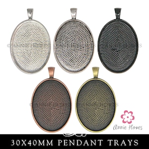 May include: Five oval pendant trays in different metal finishes: silver, antique silver, black, copper, and antique gold. Each tray measures 30x40mm.