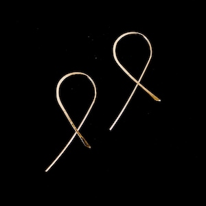 Ribbon Hoops laying flat on black background to show ribbon like shape. Made in 14k Gold Fill.