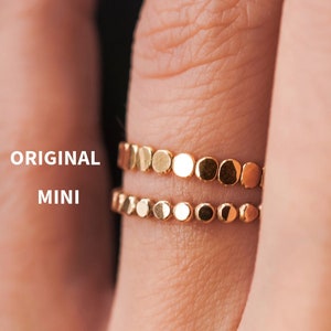 May include: Two gold rings with a circle design. The top ring is labeled "ORIGINAL" and the bottom ring is labeled "MINI".