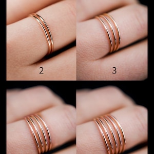 K&ouml;nnte beinhalten: Ros&eacute;goldene Ringe mit unterschiedlicher Anzahl an B&auml;ndern. Die Abbildung zeigt Ringe mit zwei, drei, vier und f&uuml;nf B&auml;ndern. Die Ringe haben ein schlichtes, elegantes Design.