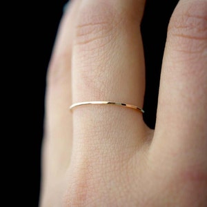Single Ultra Thin, 0.7mm thick, super skinny stacking ring worn on the Ring Finger. Featuring the 14k Gold Filled version of this ring with a textured, Hammered finish.