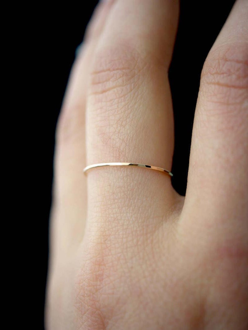 Single Ultra Thin, 0.7mm thick, super skinny stacking ring worn on the Ring Finger. Featuring the 14k Gold Filled version of this ring with a textured, Hammered finish.