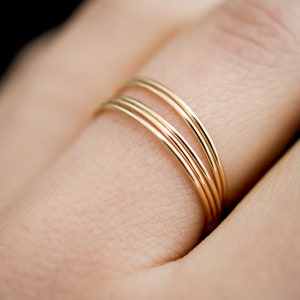 Set of 5 Smooth Ultra Thin Rings stacked together modelled on middle finger in 14k Gold Fill.