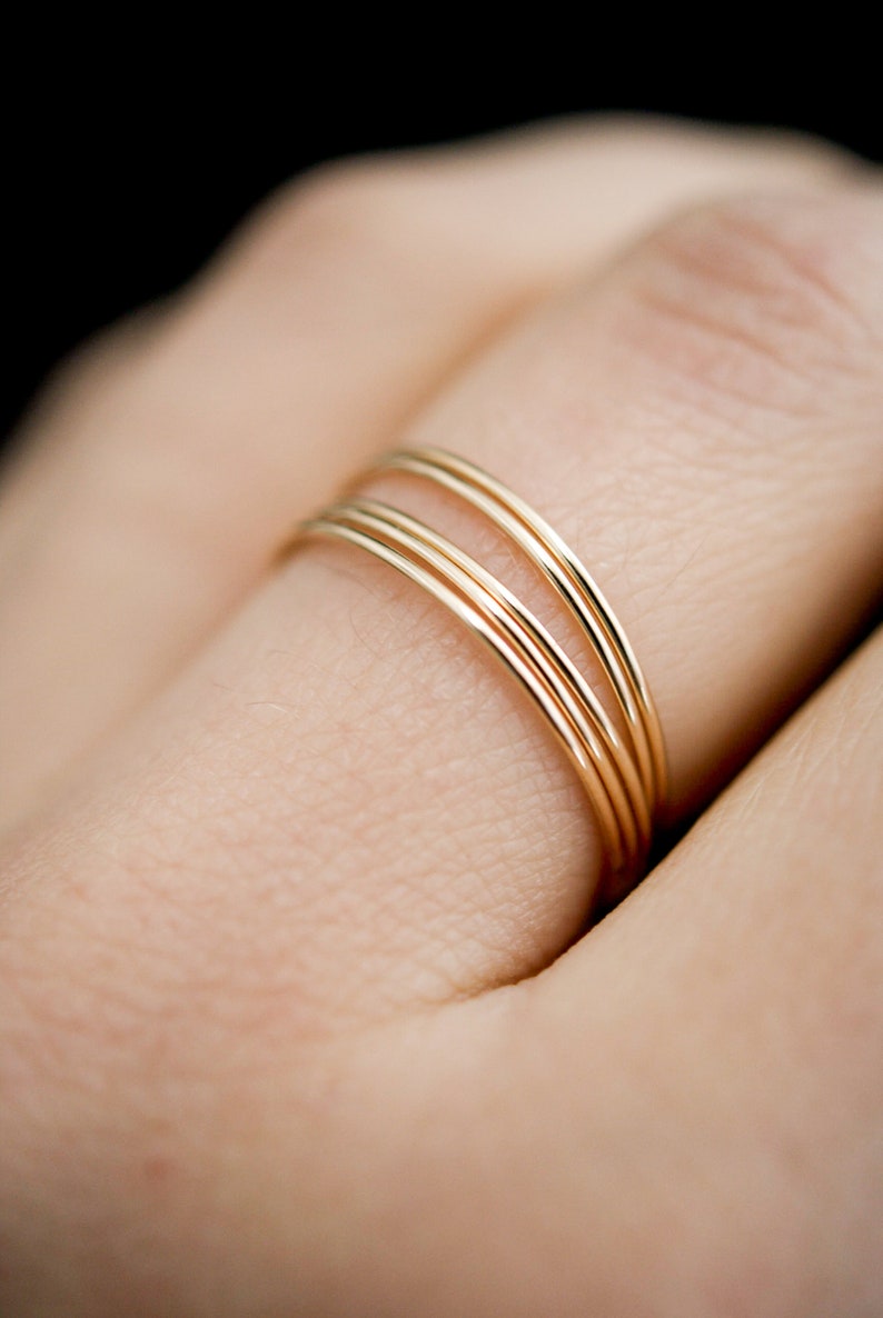 Set of 5 Smooth Ultra Thin Rings stacked together modelled on middle finger in 14k Gold Fill.